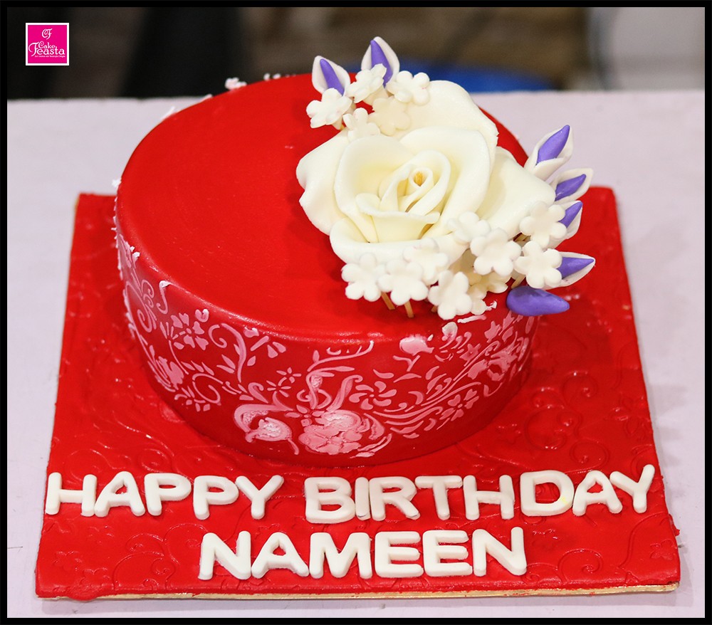 1575356077-red-base-white-flower-birthday-cake.jpg